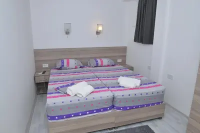 a bedroom with two beds with pillows on them at Atina Lux Hostel in Leskovac