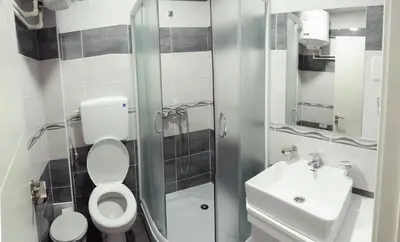 a small bathroom with a toilet and a sink at Atina Lux Hostel in Leskovac