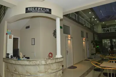 a lobby of a restaurant with a stone counter at Atina Lux Hostel in Leskovac