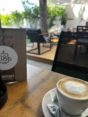 a cup of coffee sitting on a table at Laguna Green Guest House in Niš
