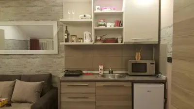 a small kitchen with a sink and a microwave at K23 apartment Milmari in Kopaonik