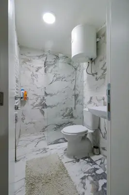 a bathroom with a toilet and a sink at Studio Apartments Maksimović in Niš