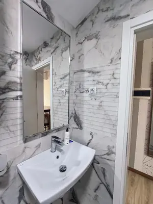 a bathroom with a sink and a mirror at Studio Apartments Maksimović in Niš