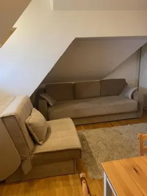 a living room with a couch and a chair at Apartments Pavle in Kopaonik