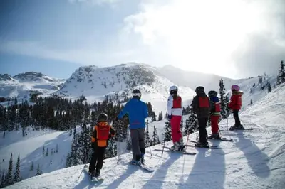 a group of people standing on top of a snow covered mountain at SM Apartments Kopaonik III in Kopaonik