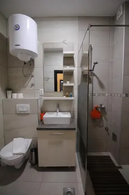 a bathroom with a toilet and a sink and a shower at Ski & Spa K2 Milmari Resort Lux in Kopaonik