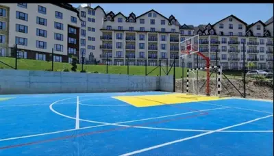 a basketball court in front of a large building at Ski & Spa K2 Milmari Resort Lux in Kopaonik