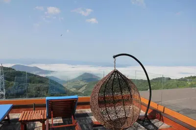 a hanging basket on a balcony with a view of mountains at Ski & Spa K2 Milmari Resort Lux in Kopaonik