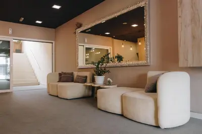 a living room with two couches and a mirror at Apostolovic Plus in Leskovac