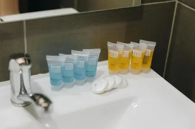a group of cups sitting on a bathroom sink at Apostolovic Plus in Leskovac