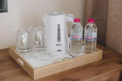 a blender and bottles of water on a wooden shelf at Apostolovic Plus in Leskovac