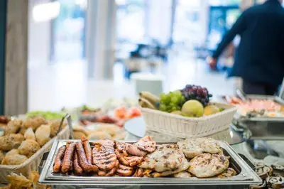 a buffet of food with meat and other foods at Apostolovic Plus in Leskovac