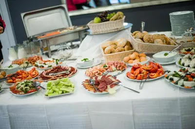 a buffet with plates of food on a table at Apostolovic Plus in Leskovac