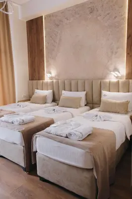 a group of four beds in a room at Apostolovic Plus in Leskovac