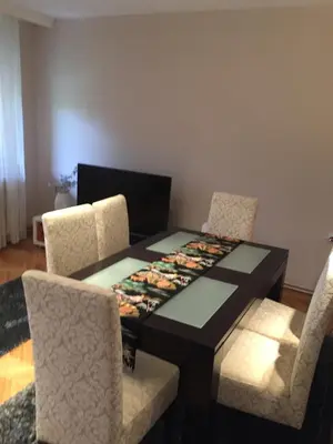 a dining room with a table and two chairs at Apartment Aloha in Vrnjačka Banja
