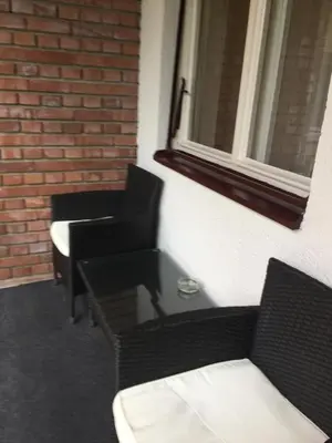 a room with two chairs and a table and a window at Apartment Aloha in Vrnjačka Banja