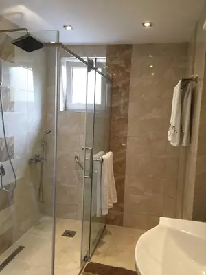 a bathroom with a shower and a tub and a sink at Apartment Aloha in Vrnjačka Banja