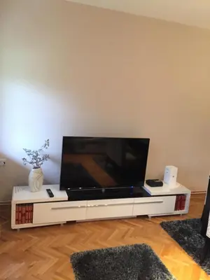 a large flat screen tv on a white entertainment center at Apartment Aloha in Vrnjačka Banja