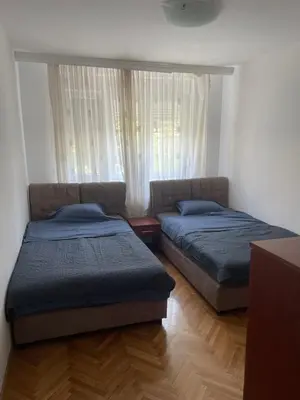 two beds in a room with a window at Apartment Aloha in Vrnjačka Banja