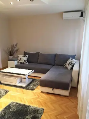 a living room with a couch and a table at Apartment Aloha in Vrnjačka Banja
