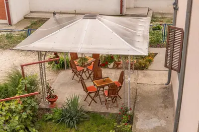 an overhead view of a table and chairs under an umbrella at Apartmani Maja Sokobanja in Soko Banja