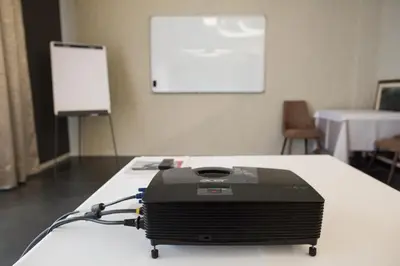 a black printer sitting on a table in a room at Hotel Ideo Lux in Niš