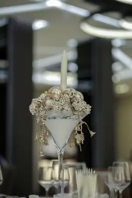 a candle in a martini glass on a table at Hotel Ideo Lux in Niš