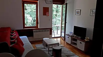 a living room with a red couch and a tv at Apartment Blagojevic in Vrnjačka Banja