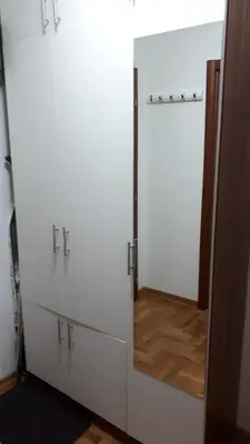 a white wardrobe with a mirror in a room at Apartment Blagojevic in Vrnjačka Banja