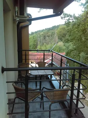 a balcony with a table and chairs and a view at Apartment Blagojevic in Vrnjačka Banja