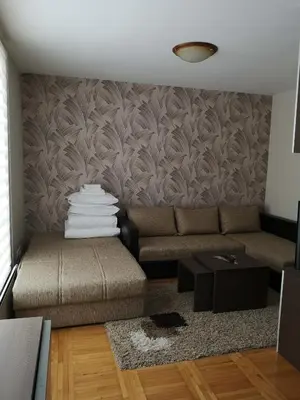 a living room with a couch and a table at Apartman 33 Kraljevi Čardaci in Kopaonik