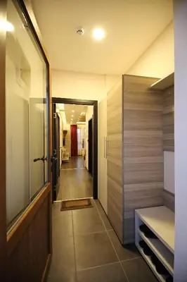 a hallway leading into a bathroom with a door and a hallway at Astoria Lux - K16 Milmari in Kopaonik