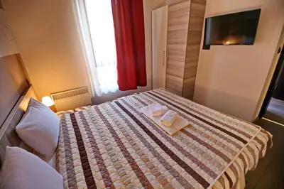 a hotel room with a bed with two towels on it at Astoria Lux - K16 Milmari in Kopaonik