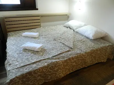 a bedroom with a bed with two pillows on it at Apartment Sofi Yeti in Kopaonik