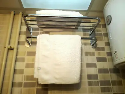 a towel rack with three towels on it in a bathroom at Apartment Sofi Yeti in Kopaonik