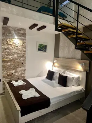 a bedroom with a bed with two towels on it at Exclusive Spot FREE parking in Niš