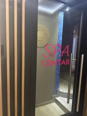 a sign for a spa center on the wall of a room at Exclusive Spot FREE parking in Niš