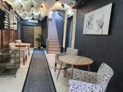 a restaurant with tables and chairs and a staircase at Exclusive Spot FREE parking in Niš