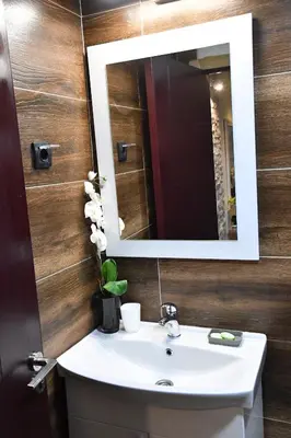 a bathroom with a sink and a mirror at Exclusive Spot FREE parking in Niš