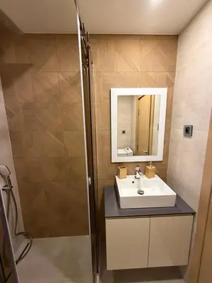 a bathroom with a sink and a mirror at Apartments Konaci Centar in Kopaonik