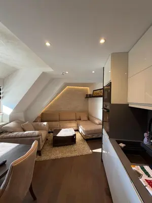 a living room with a couch and a table at Apartments Konaci Centar in Kopaonik