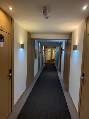 a corridor of a hallway with doors and a long aisle at Apartments Konaci Centar in Kopaonik