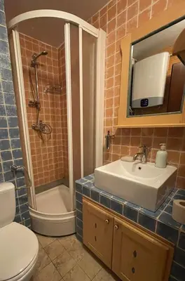 a bathroom with a sink and a shower and a toilet at Apartments Konaci Centar in Kopaonik