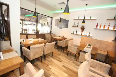 a restaurant with tables and chairs in a room at Apartment Dream Konaci in Kopaonik
