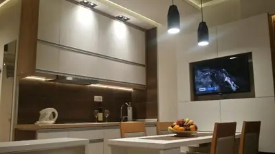 a kitchen with a table with a bowl of fruit on it at Apartment Dream Konaci in Kopaonik
