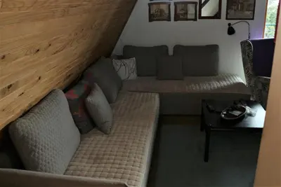 a living room with two couches and a table at Holiday Home Dana Kopaonik in Kopaonik
