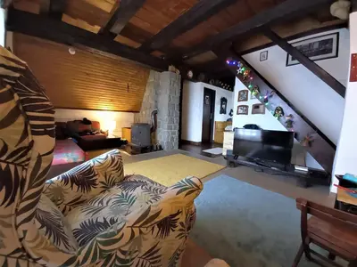 a living room with a couch and a television at Holiday Home Dana Kopaonik in Kopaonik