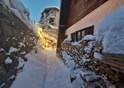 an alley covered in snow next to a building at Holiday Home Dana Kopaonik in Kopaonik