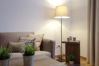 a living room with a couch and a lamp and a table at Brzeće Center Apartments in Kopaonik