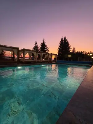 a swimming pool at night with a marquee at Marrilux apartments Residence Hill in Kopaonik